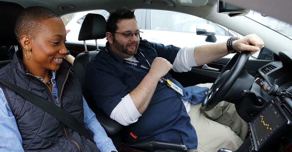Two people in a car listening to an internal communications podcast