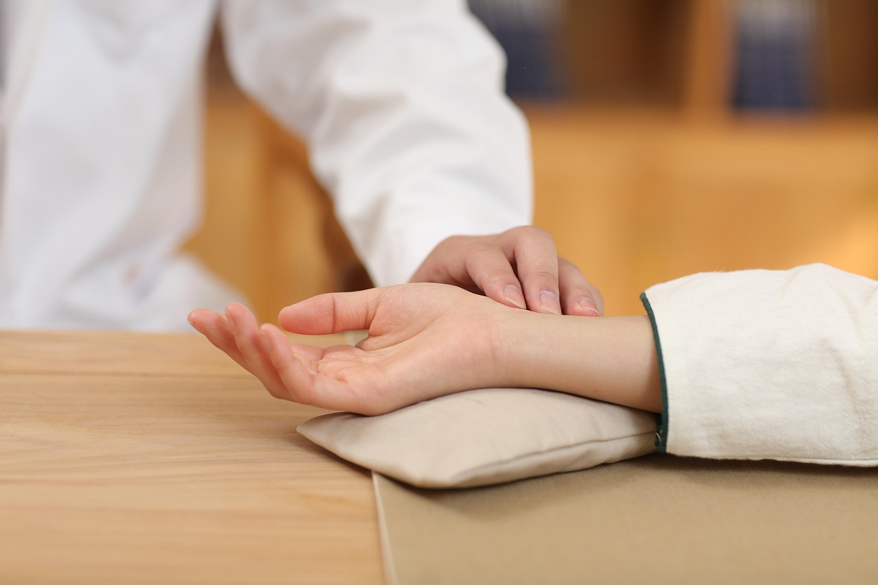 Healthcare professional taking a patient's pulse, illustrating whether or not thought leaders have one.