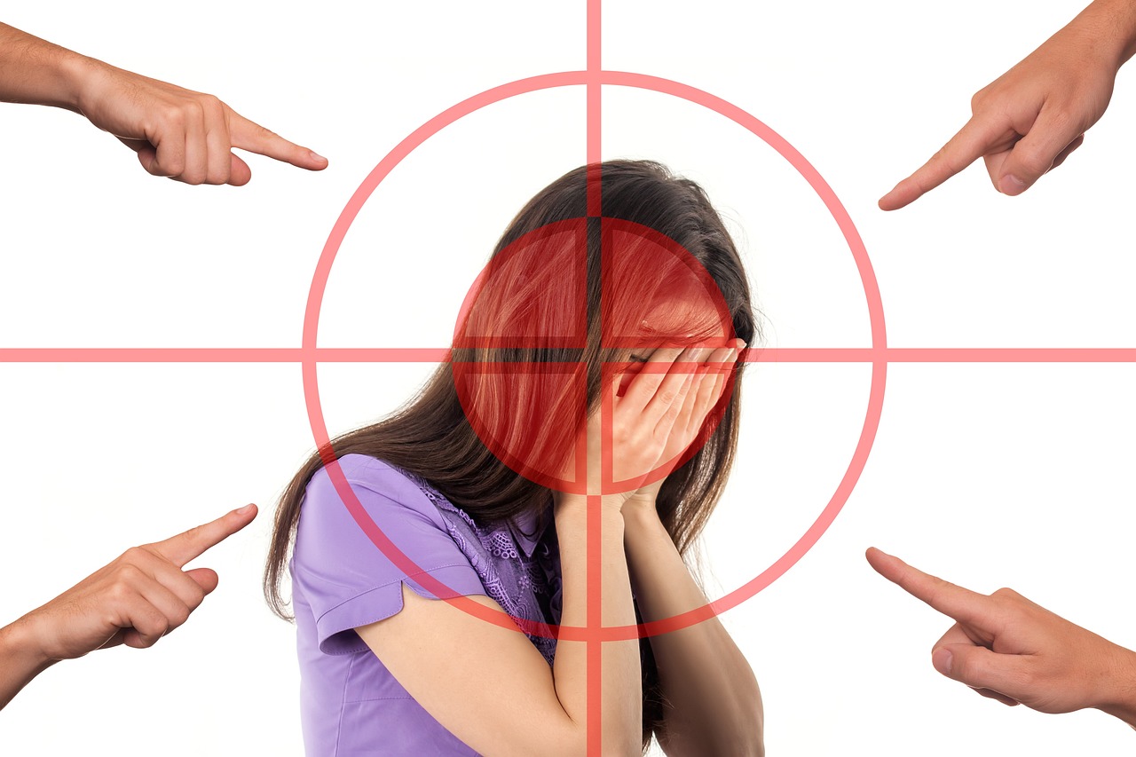 Embarrassed woman with fingers pointing at her because she was caught doing bad thought leadership.