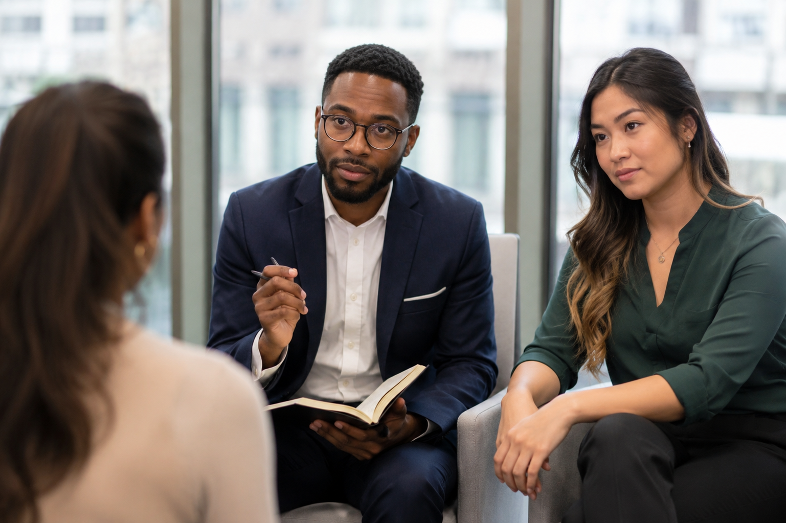Two people leaning forward listening intently to an executive thought leader giving their take on something.